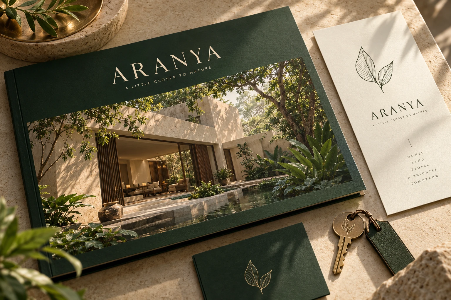 Forest-green Aranya brochure and stationery concept on natural stone